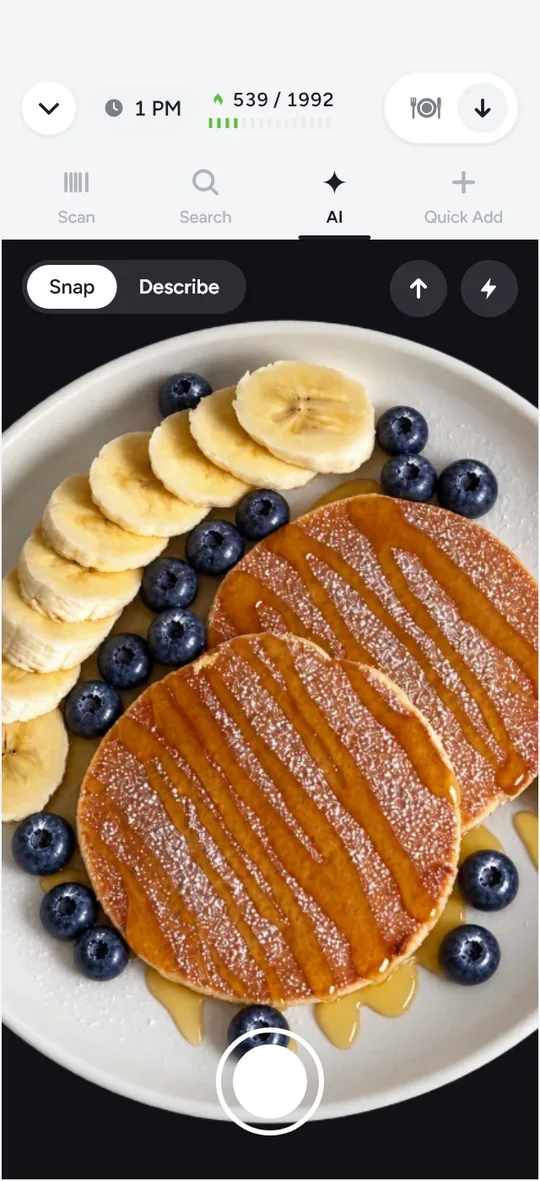 The AI camera in Snap mode, aimed at a plate of pancakes with banana slices, blueberries and syrup, ready to take the photo.